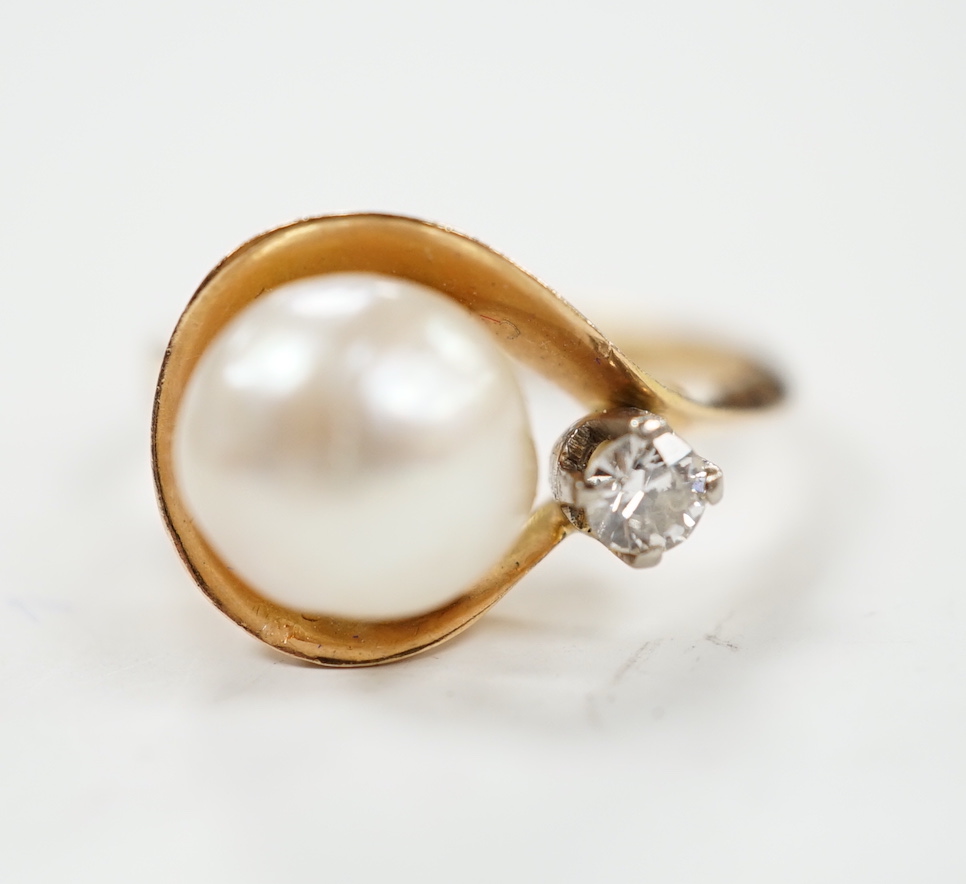 A yellow metal , single stone cultured pearl and single stone diamond set ring, size J, gross weight 4.8 grams.